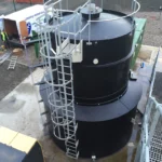 Black chemical tank with ladder access outside
