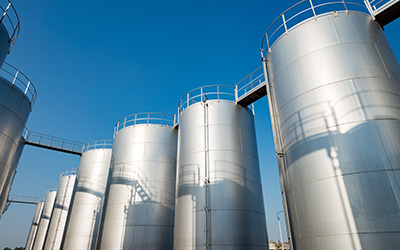 multiple silver tanks on a blue sky background