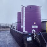 side angle of two purple chemical storage tanks