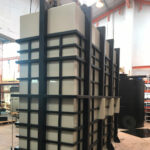 Ivory and black rectangular vertical tanks in a warehouse
